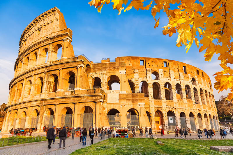 Rome Colosseum surrounded by autumn foliage on Italy vacation