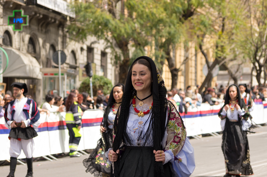Girl in traditional Sardinian costume at Italy cultural festival