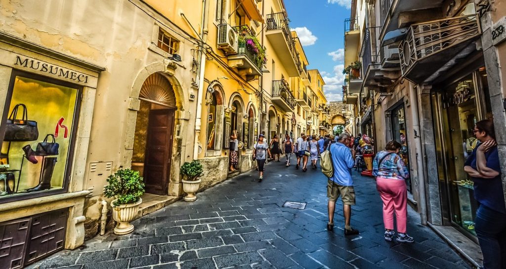Tourists exploring historic Sicily on a guided tour of Italy