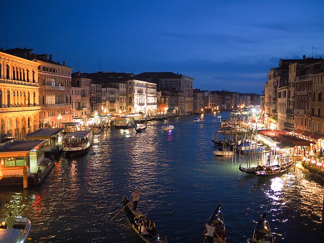 Venice canals and bridges illuminated at night on Italy tour